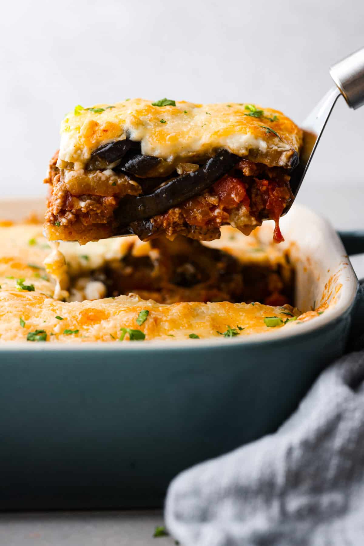 A slice of moussaka being served.