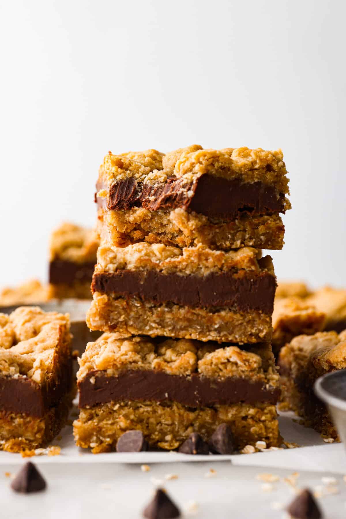 Close view of oatmeal fudge bars stacked with a bite out of the top bar.
