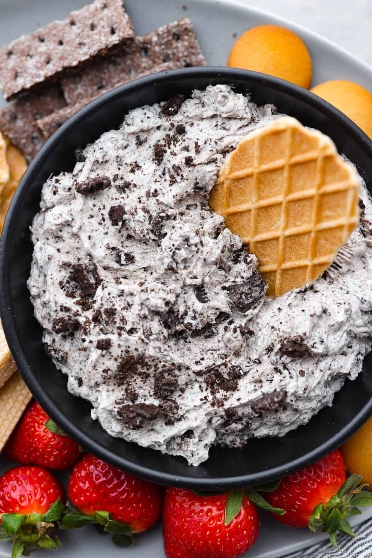 Closeup of the Oreo dip with a piece of waffle cone stuck into it.