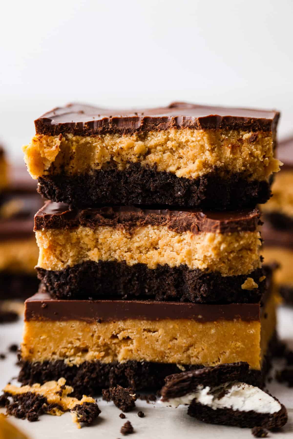 Dessert bars stacked on top of each other. Two have a bite taken out of them.