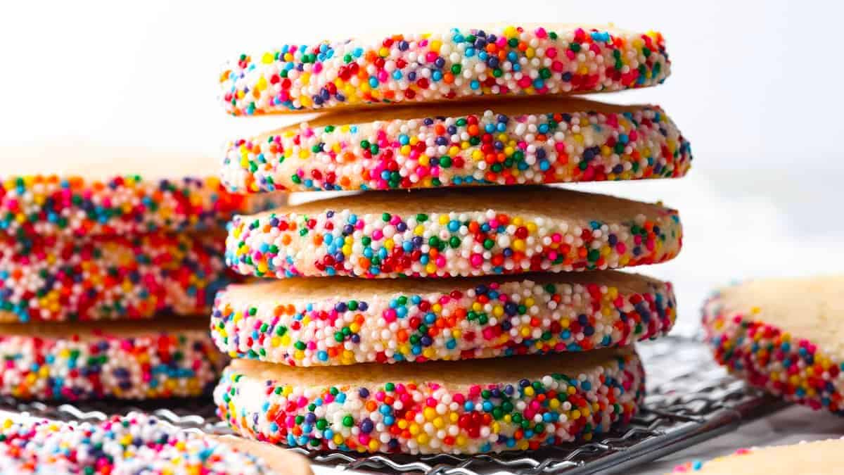 A stack of cookies with sprinkles on the edges of them. 