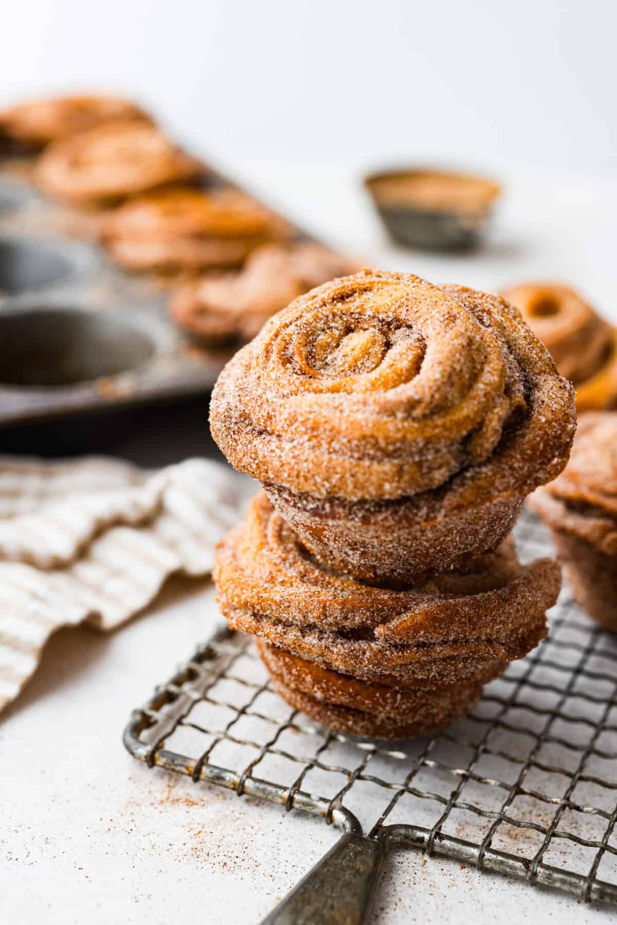 2 cruffins stacked on top of each other on a wire rack.