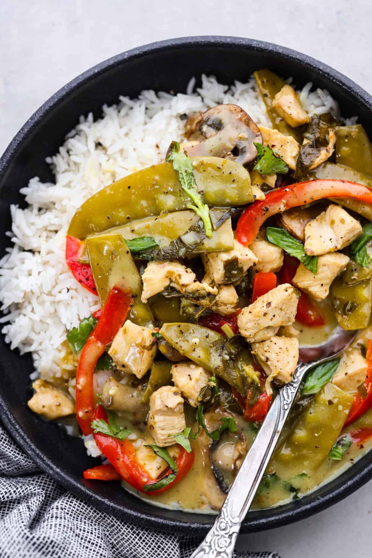 Green curry with chicken served over white rice.