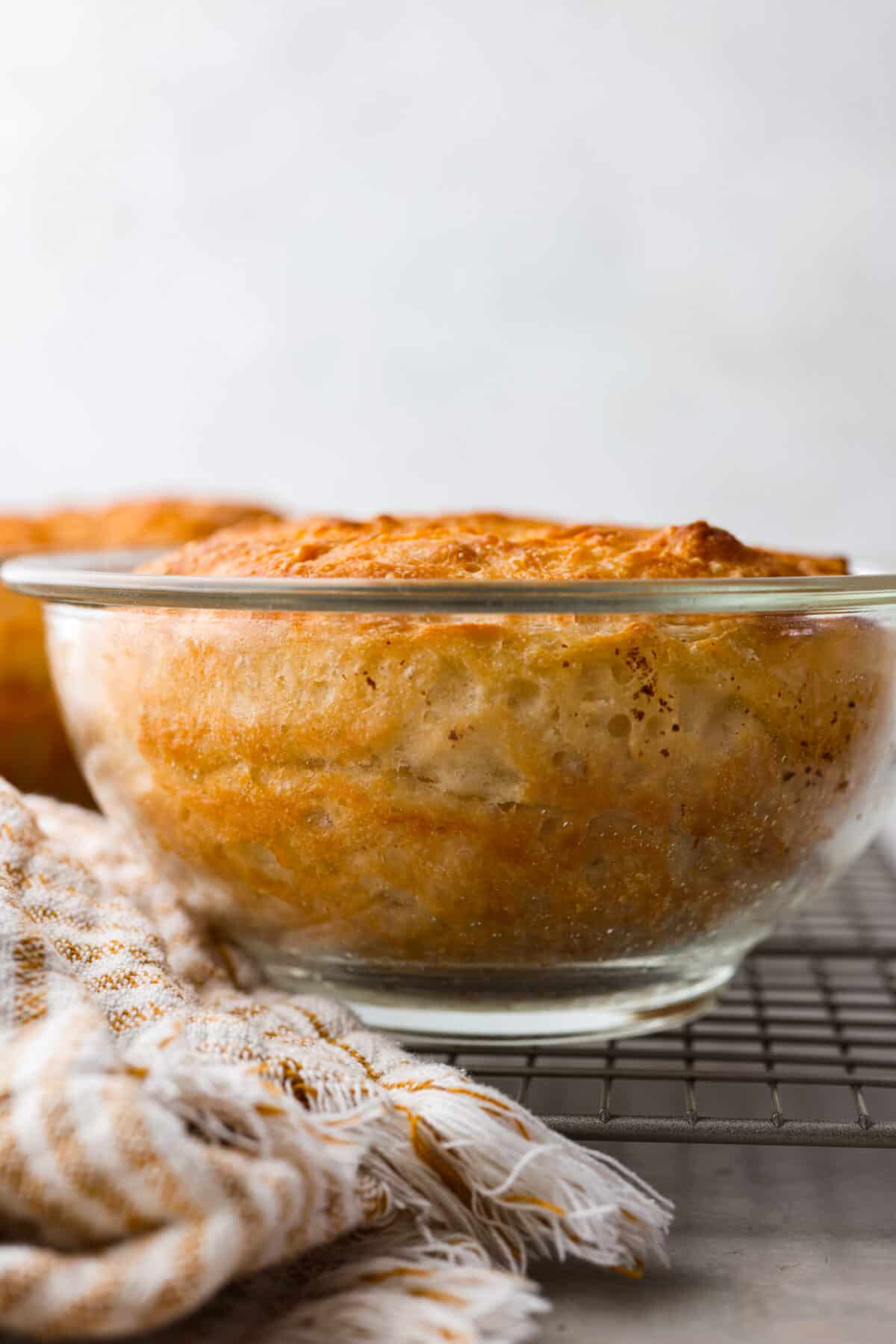 Close side view of the peasant bread baked in a glass bowl.