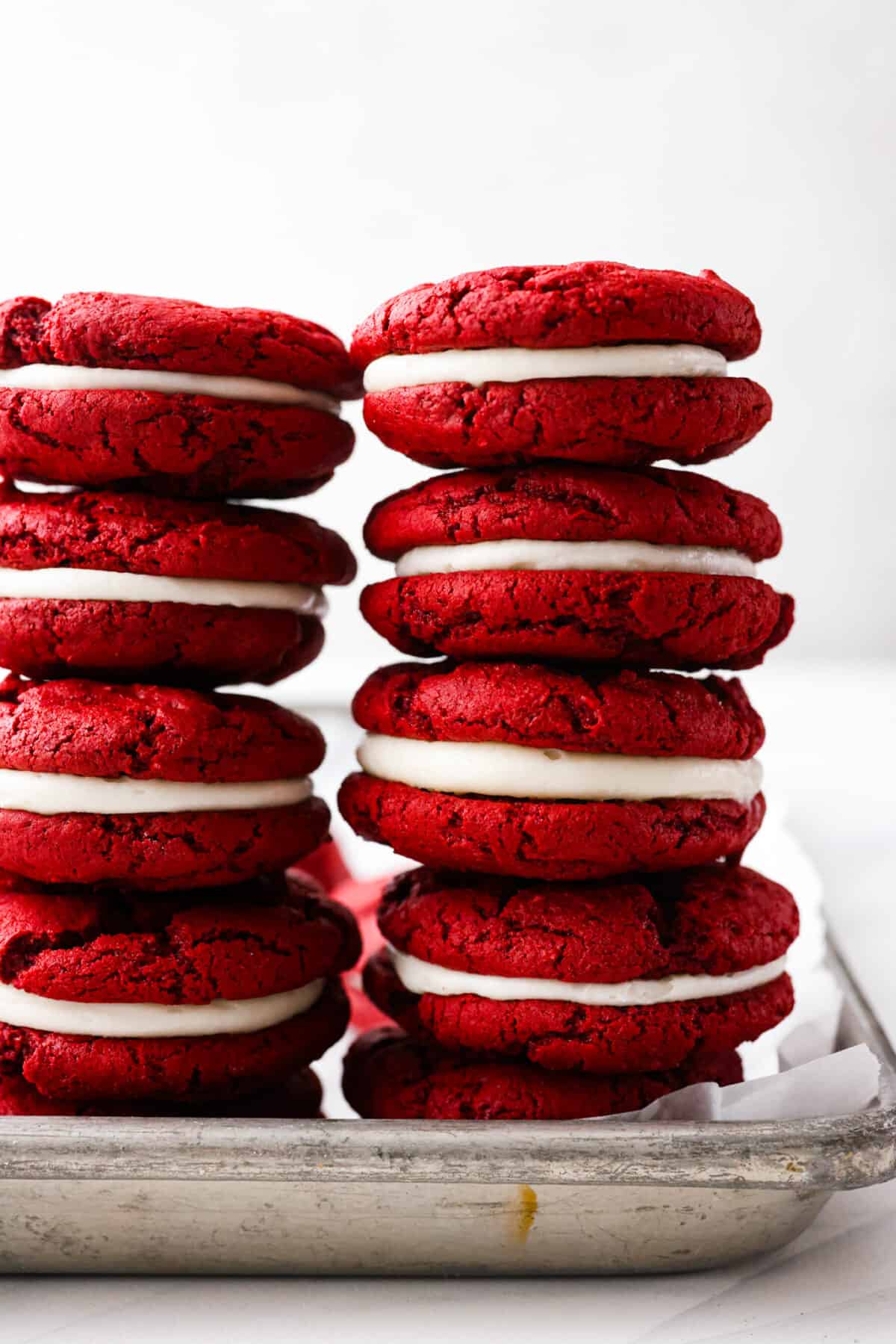 Close view of red velvet Oreos stacked.