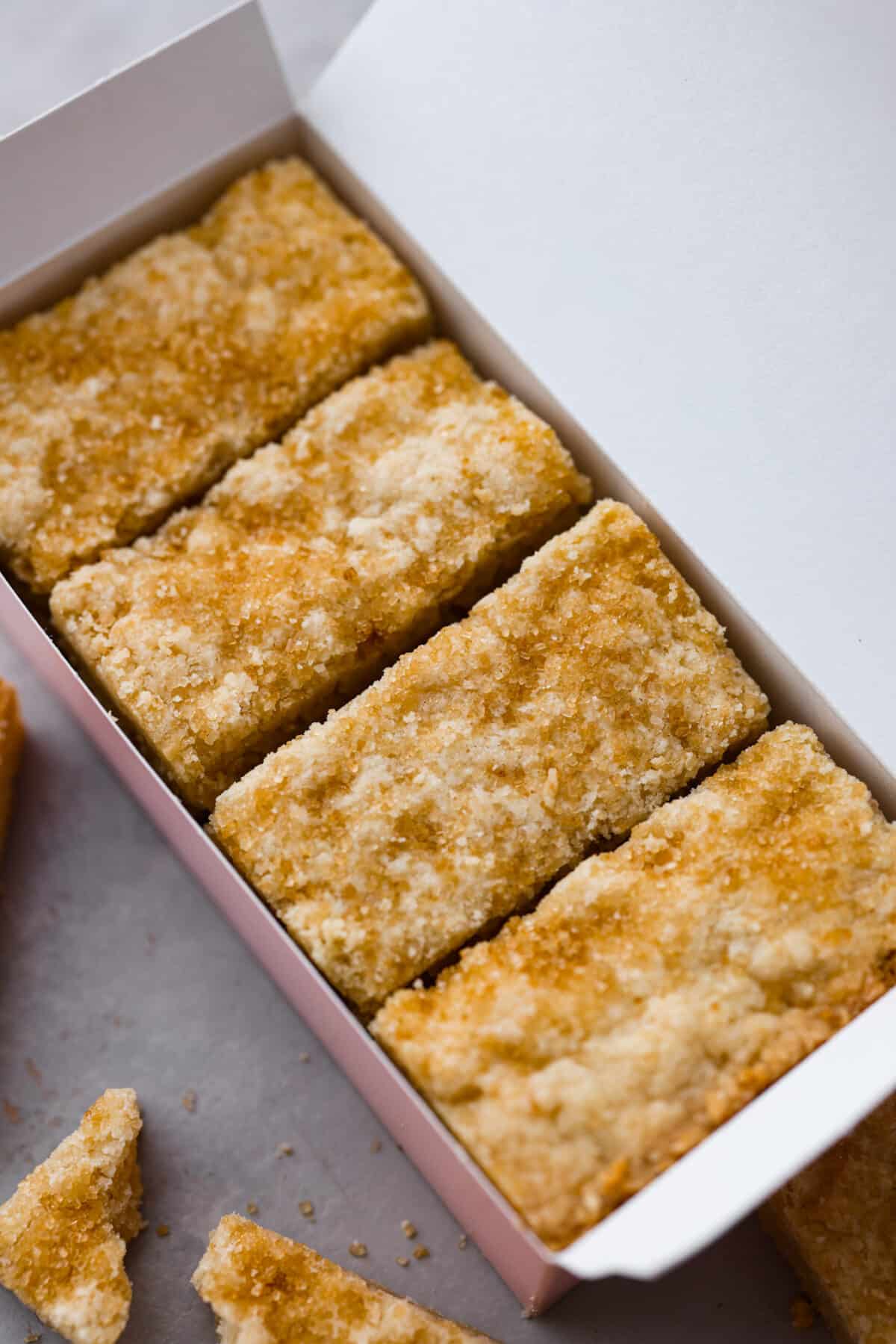 A closeup of Ted Lasso biscuits in a pink box. 