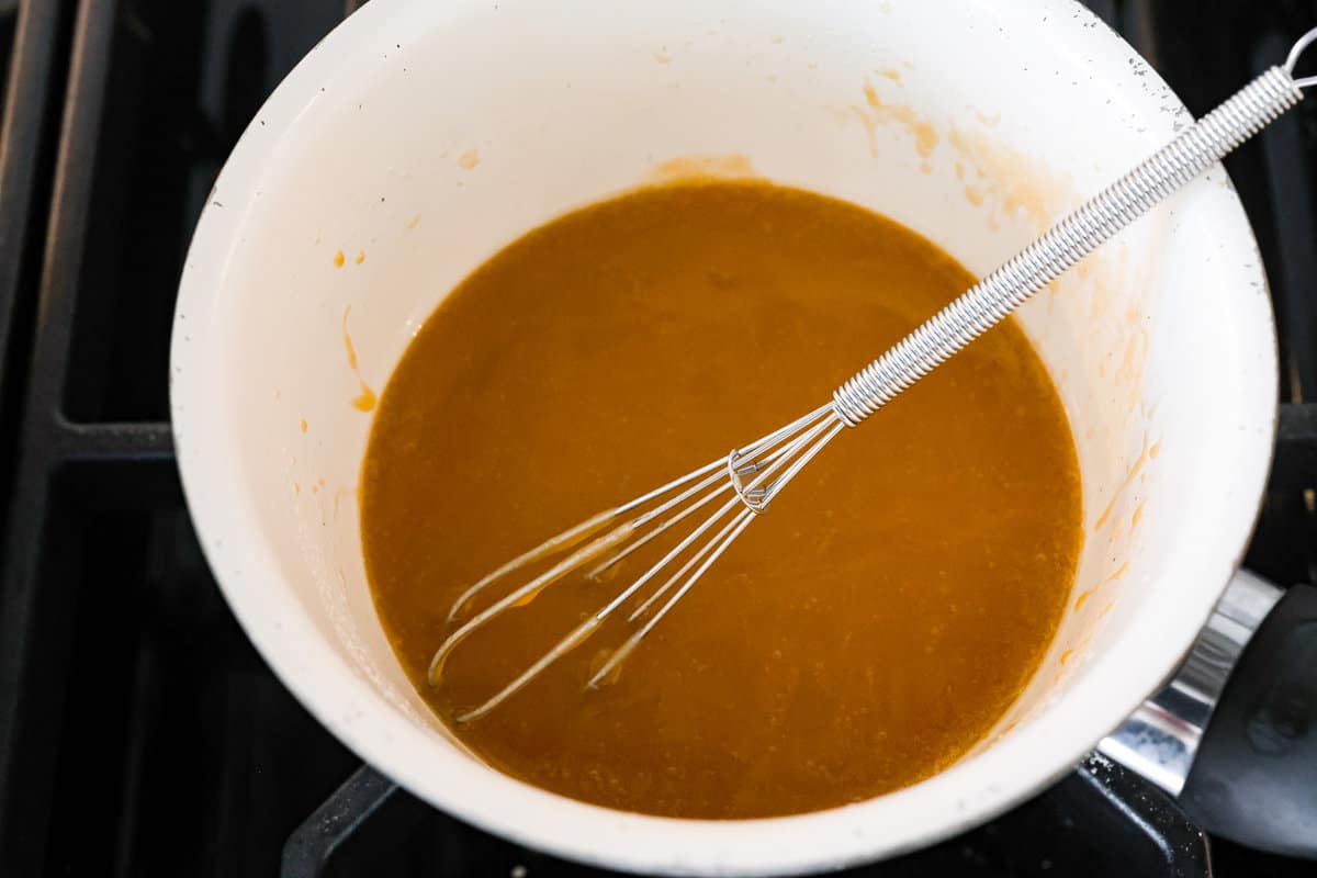 This air fryer ham is moist and flavorful with the most delicious caramelized honey glaze! It's super easy to make and tastes so incredible, you'll never want to cook ham any other way! Your friends and family will all be asking for the recipe! The honey glaze being whisked together.
