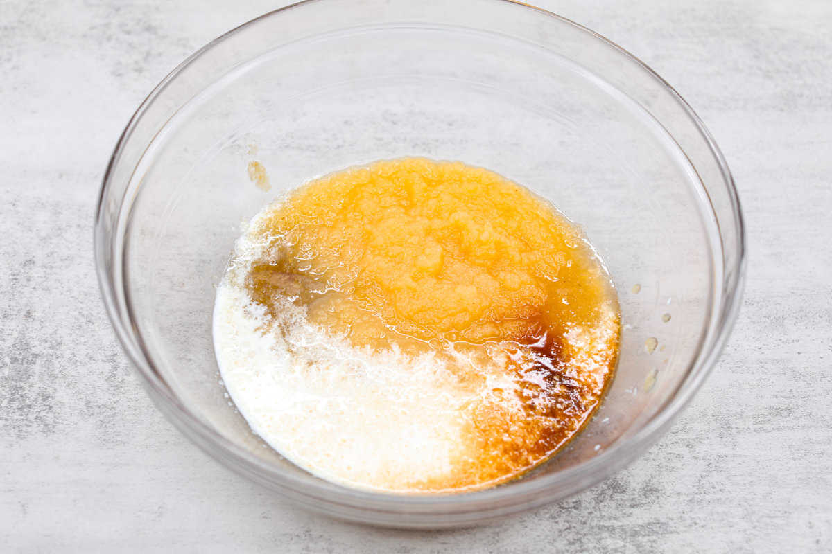 I see a batch of sweet and ultra-moist applesauce muffins in your future! They’re so delicious and made with all-natural sugars. The perfect breakfast, snack, dessert, you name it! The wet ingredients being combined.