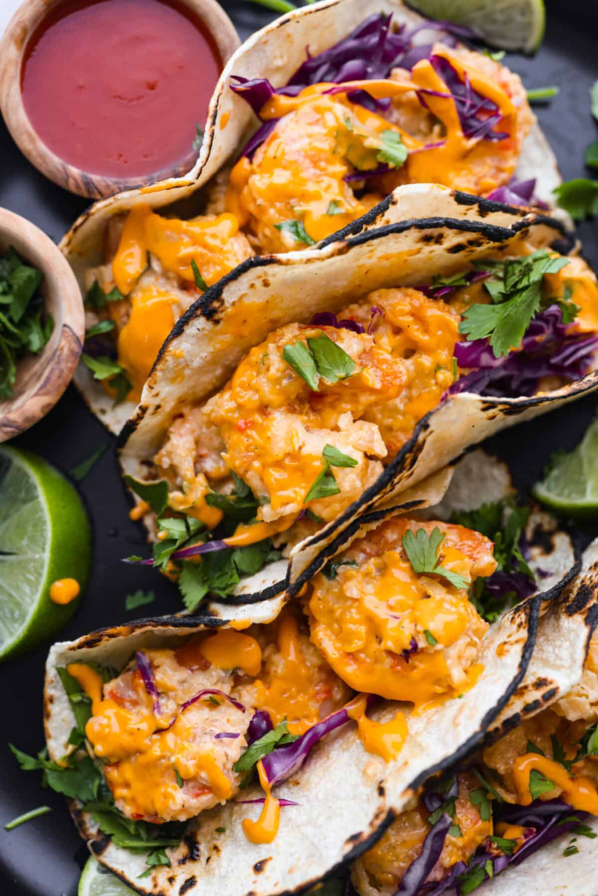 A close up of bang bang shrimp tacos. 