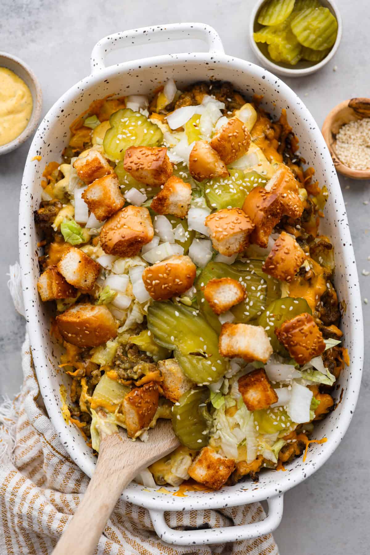 Top-down view of a Big Mac casserole topped with croutons.