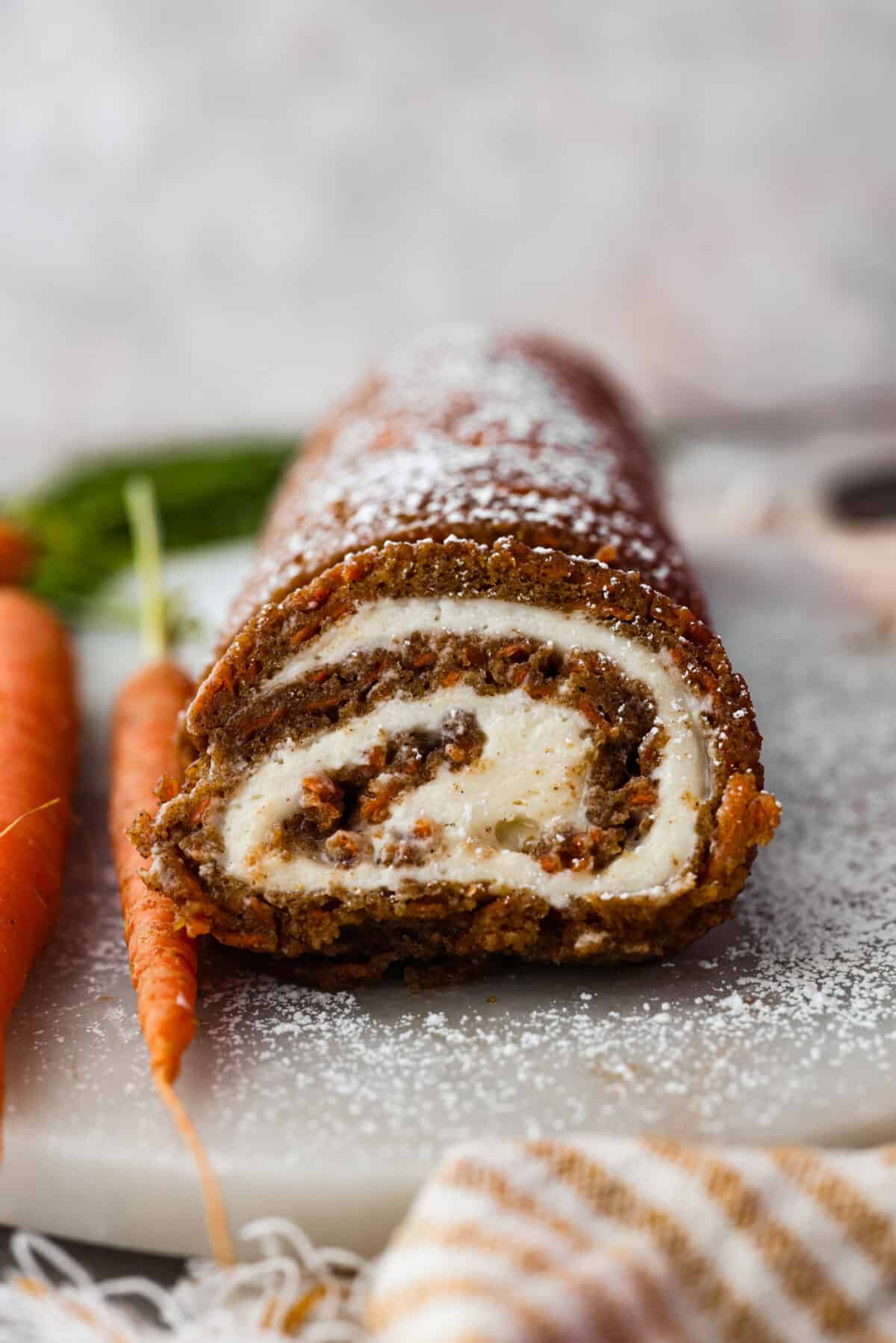 Front view of a carrot cake roll cut into slices.