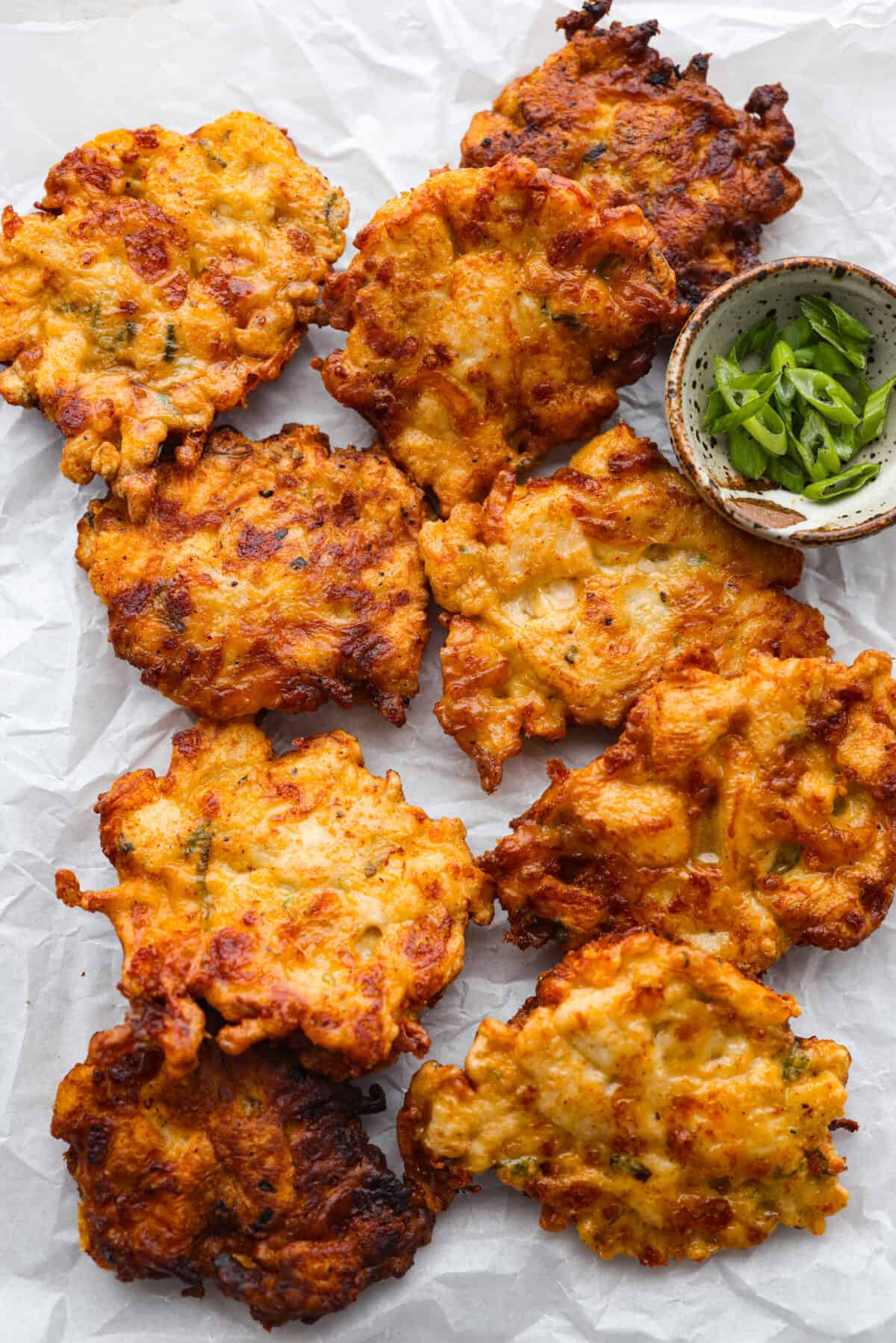 Cooked fritters on parchment paper