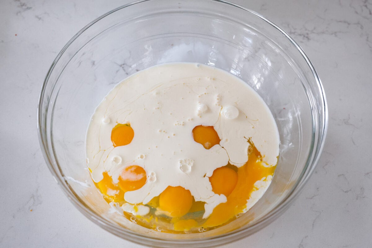 The egg and milk mixture in a glass bowl.