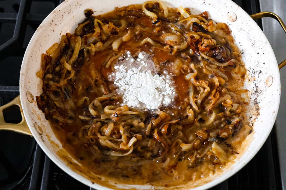 French Onion Pork Chops have all of the wonderful flavors of the classic soup in pork chop form! Caramelized onions and seared pork chops are joined with a savory sauce and two types of cheese for an amazing meal. Everything is cooked in one pan for a quick and easy weeknight dinner! Creating the onion gravy.