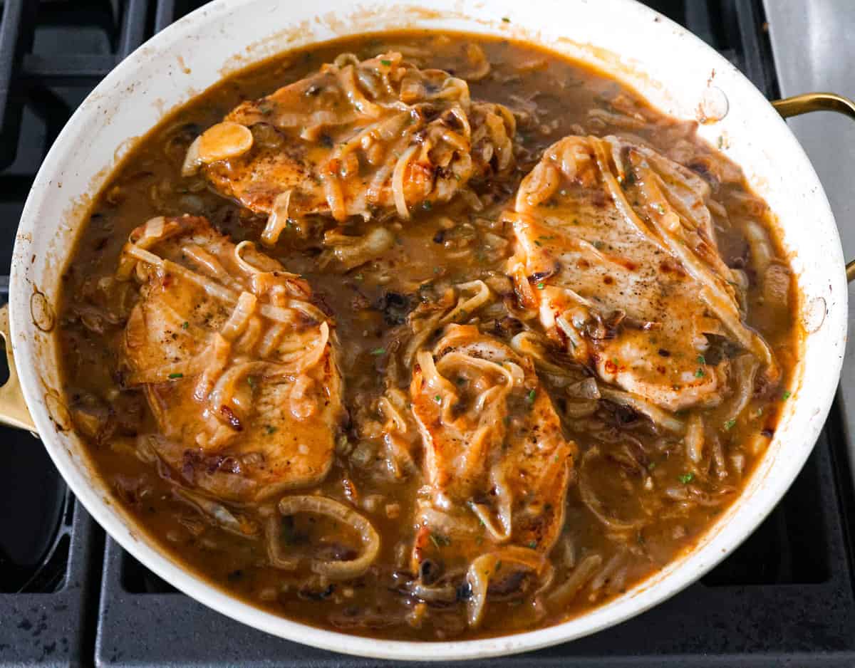 French Onion Pork Chops have all of the wonderful flavors of the classic soup in pork chop form! Caramelized onions and seared pork chops are joined with a savory sauce and two types of cheese for an amazing meal. Everything is cooked in one pan for a quick and easy weeknight dinner! 4 French onion pork chops