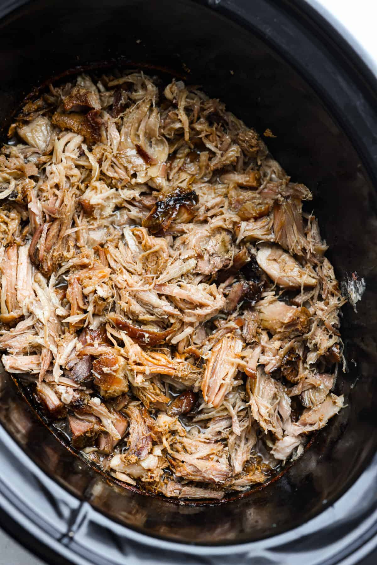 Top view of the shredded kalua pork in the slow cooker.