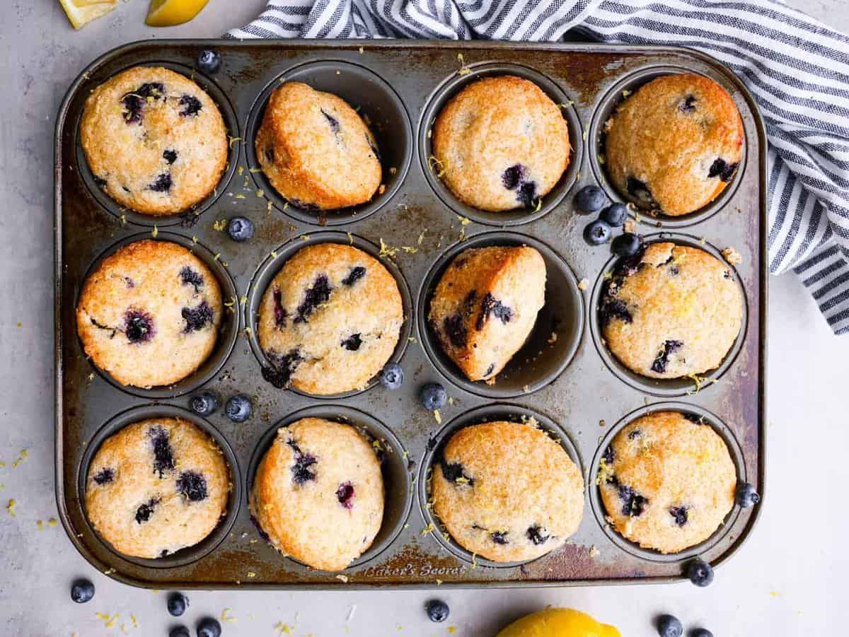 The top view of blueberry muffins in a muffin tin. 