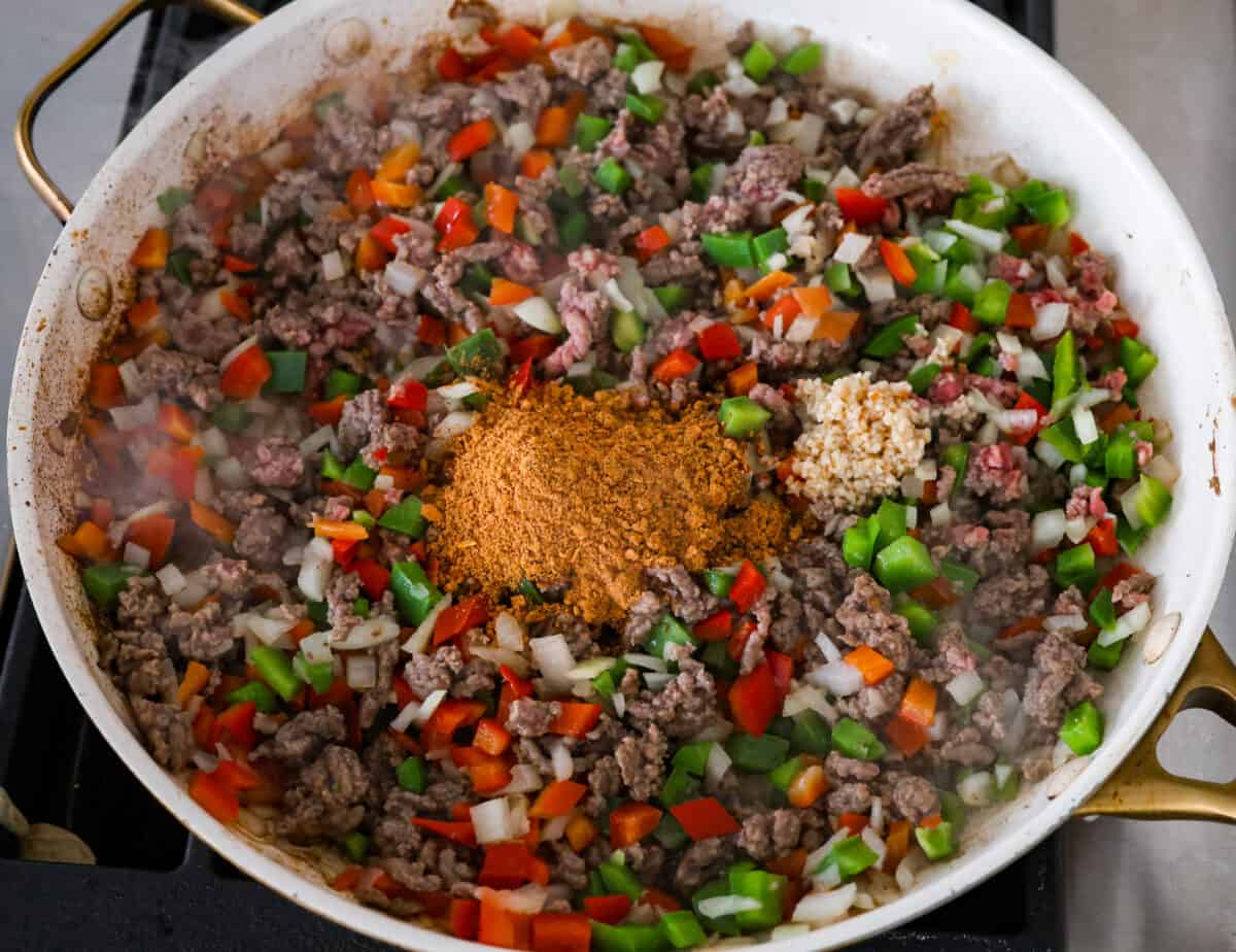 The beef and vegetables being sauteed together.