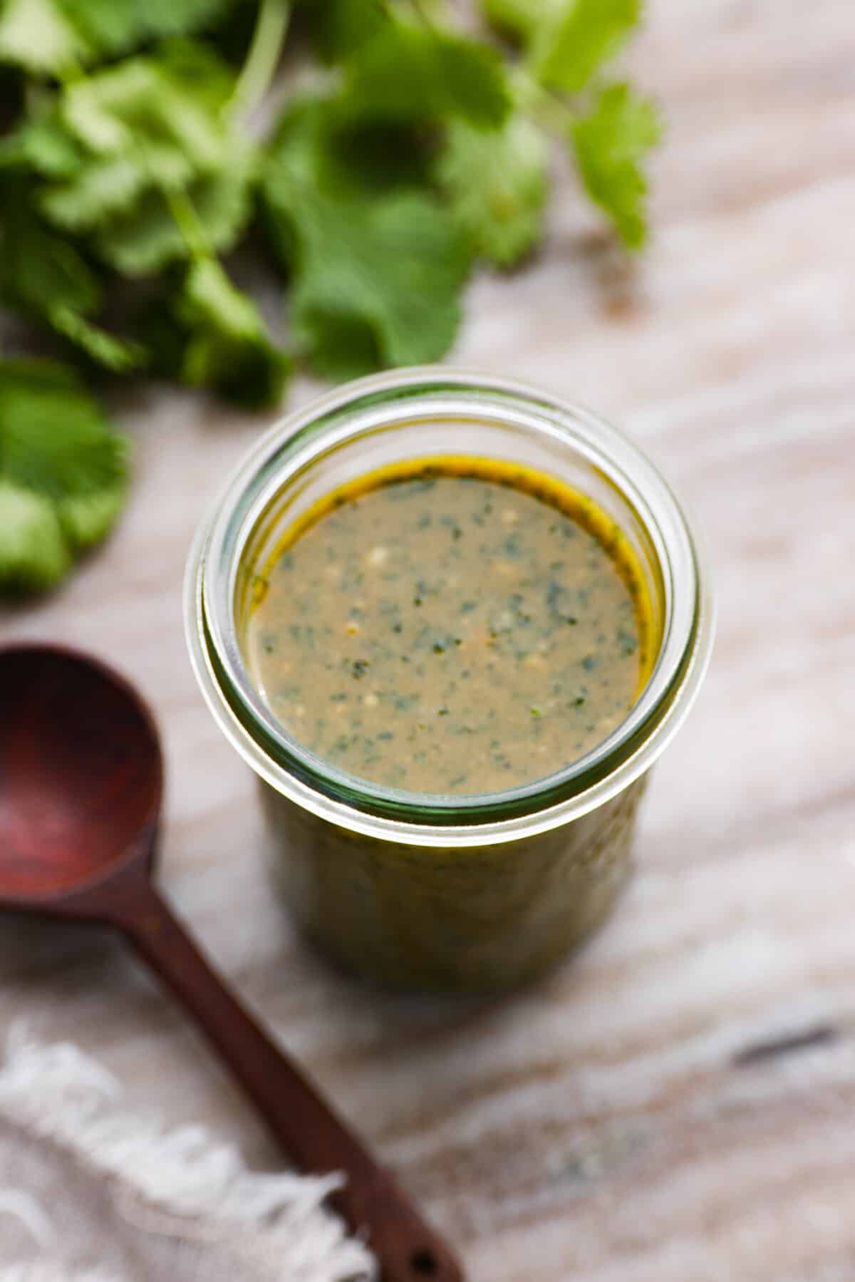 Green dipping sauce in a glass jar.