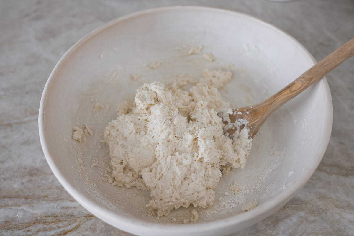 Tender and fluffy 7-up biscuits rise to perfection and instantly become everyone's favorite biscuit! It only takes 4-ingredients to create this melt-in-your-mouth biscuit recipe! Third photo of the dough formed in a bowl.