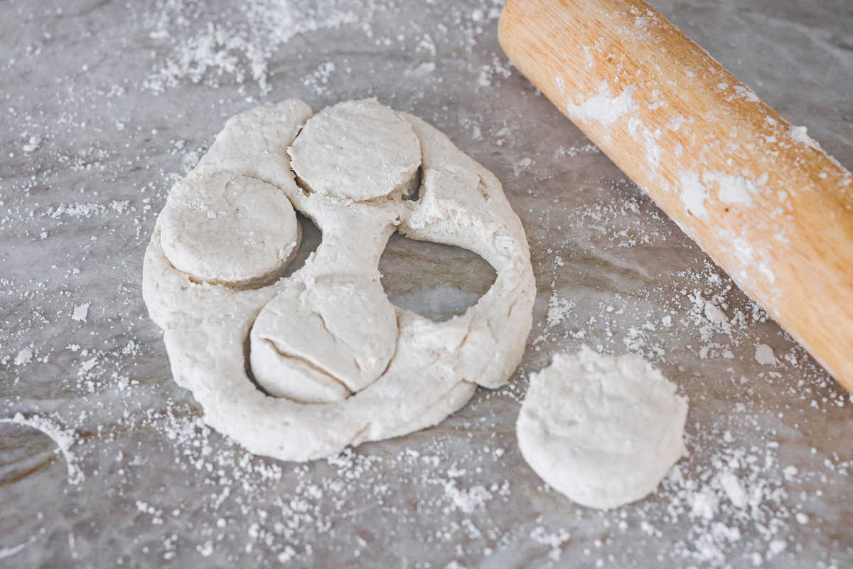 Tender and fluffy 7-up biscuits rise to perfection and instantly become everyone's favorite biscuit! It only takes 4-ingredients to create this melt-in-your-mouth biscuit recipe! Fourth photo of the 7 up biscuits rolled out and cut into biscuit shapes.