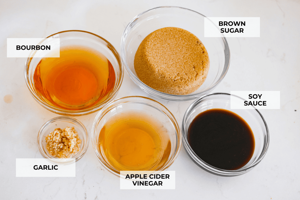 All of the marinade ingredients in separate glass bowls.