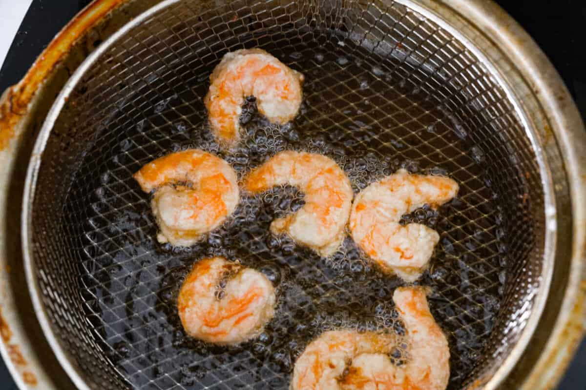 Shrimp being cooked in oil. 