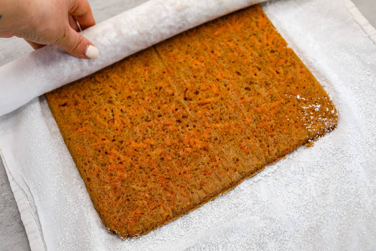 The carrot cake being unrolled 