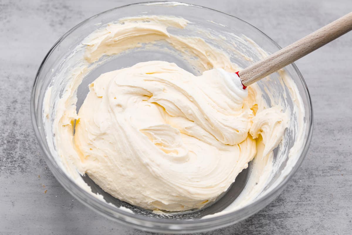 Meet lemon tiramisu! The most amazing citrusy twist on a classic Italian dessert. The layers of mascarpone cream and lemon curd will have you reaching for another slice! Mixing together with the lemon curd.