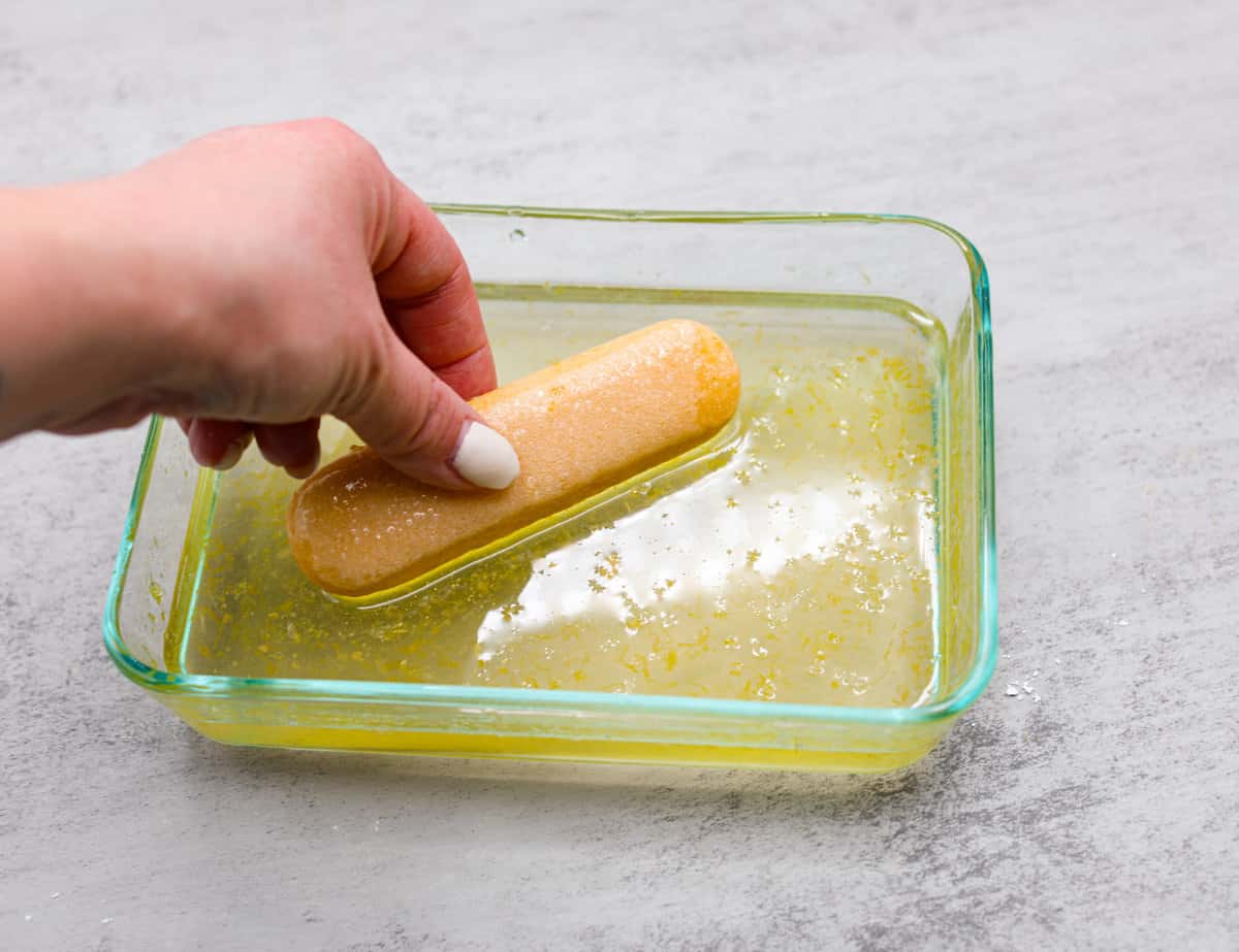 Meet lemon tiramisu! The most amazing citrusy twist on a classic Italian dessert. The layers of mascarpone cream and lemon curd will have you reaching for another slice! Soaking the ladyfingers in lemon syrup to act as the base of the lemon tiramisu.