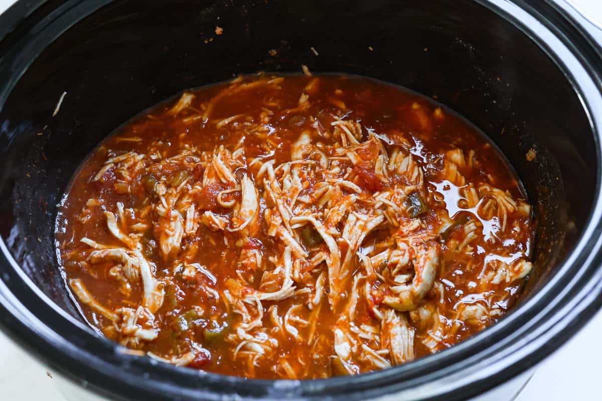 Weeknight dinner made easy with this crockpot salsa chicken! Tender flavorful chicken that only takes 5 ingredients to make. It's a versatile recipe the whole family will love! Shredded chicken added back to the slow cooker.
