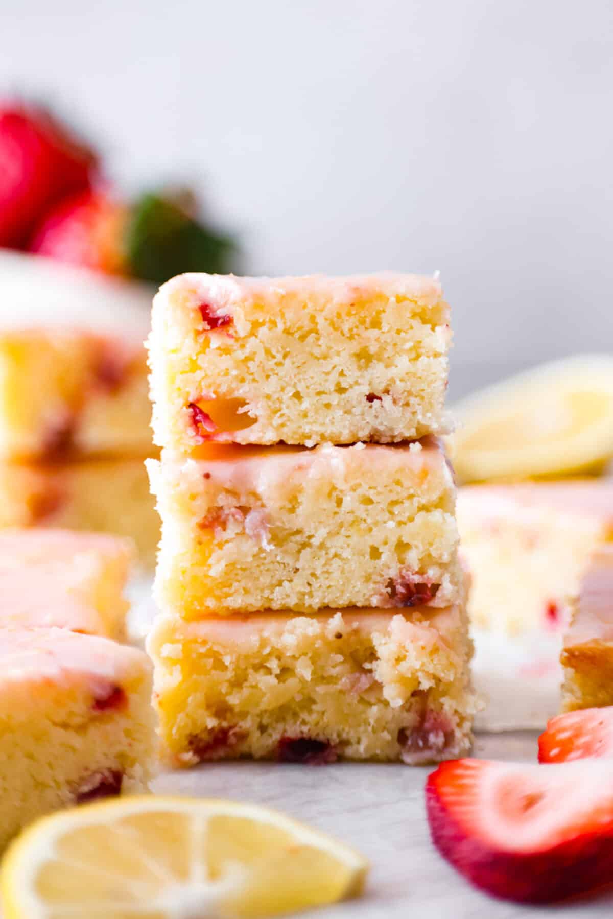 3 strawberry lemon blondie slices stacked on top of each other.