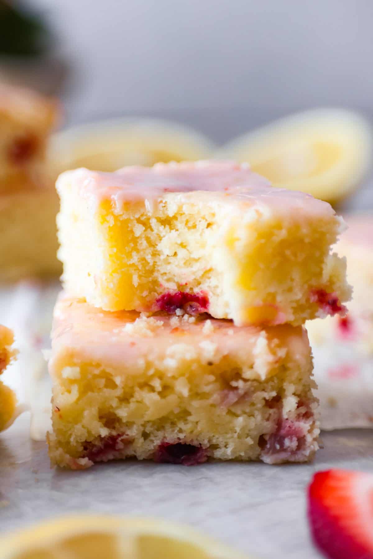 Closeup of 2 strawberry lemon blondies stacked on top of each other.