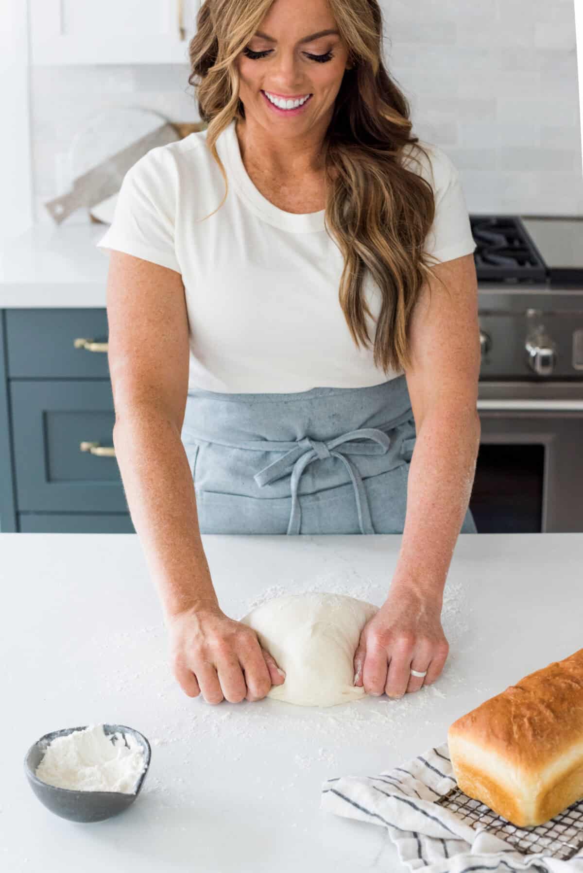 Close view of Alyssa kneading bread for this beginner's guide to baking bread.