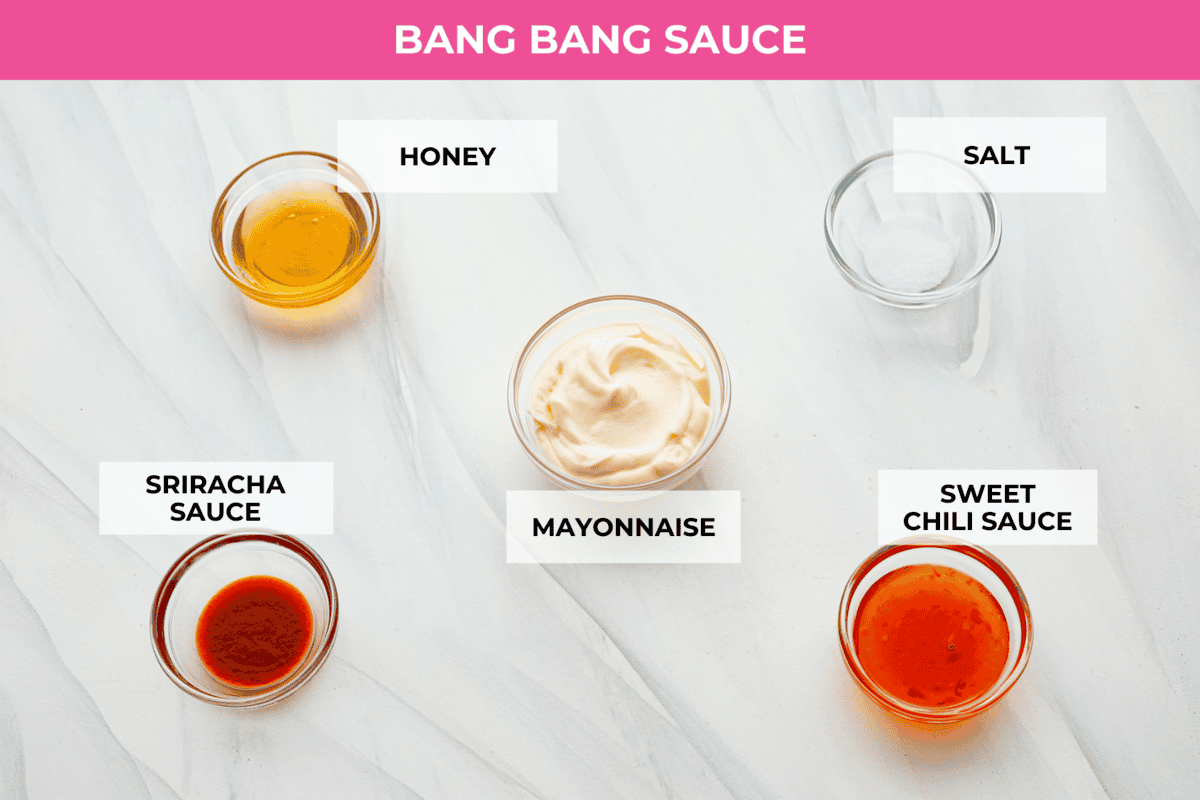 These Bang Bang Shrimp Tacos are made with deliciously crunchy shrimp cooked to perfection and coated in a special sauce that's just bursting with flavor! It's a meal that's sure to impress. Ingredients on the counter in separate bowls to make bang bang sauce.