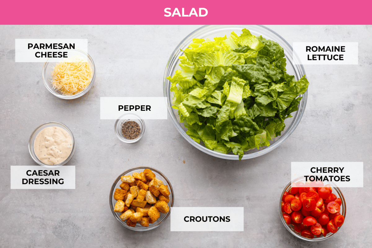 Fresh and delicious Grilled Chicken Caesar Salad is a crowd-pleasing hearty salad with tender grilled chicken, crisp romaine lettuce, cherry tomatoes, shredded parmesan cheese, and crunchy croutons! Top view of labeled ingredients for the salad.