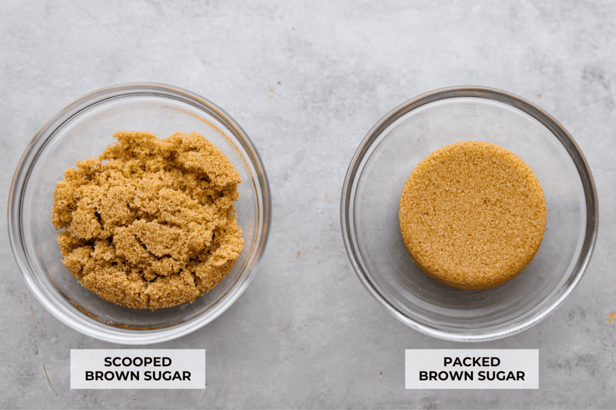 A photo of scooped brown sugar in a glass bowl next to packed brown sugar in a bowl showing the difference. 