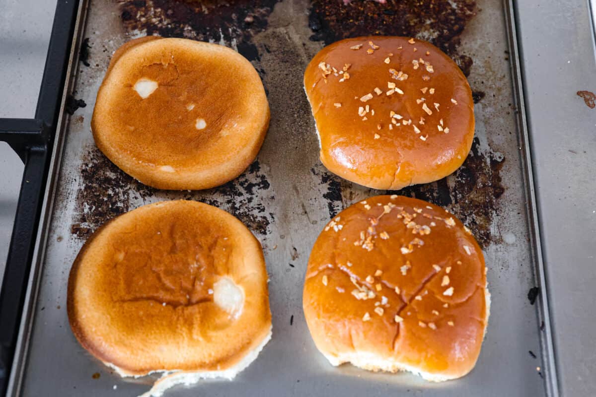 A phot showing how to add butter and sesame seeds to the buns. 