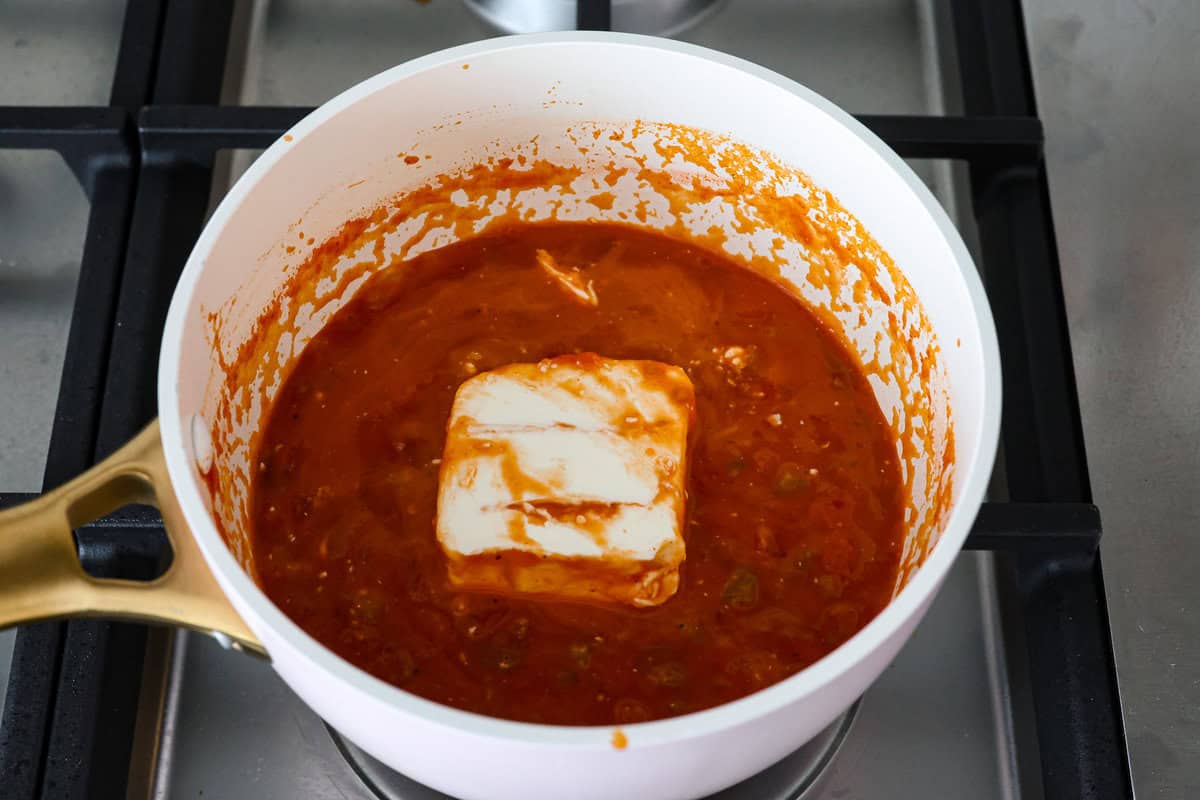 A new enchilada is in town! Get ready for the bold flavors in these buffalo chicken enchiladas! Chicken enchiladas loaded with cheese and smothered in a creamy buffalo enchilada sauce. Third photo of the cream cheese added to the sauce.
