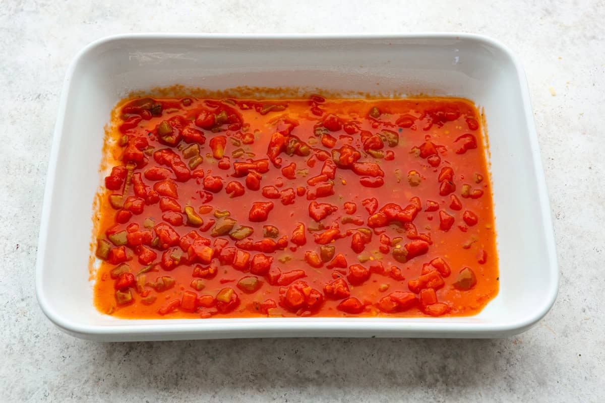 A new enchilada is in town! Get ready for the bold flavors in these buffalo chicken enchiladas! Chicken enchiladas loaded with cheese and smothered in a creamy buffalo enchilada sauce. Second photo of the sauce in the bottom of the baking dish.
