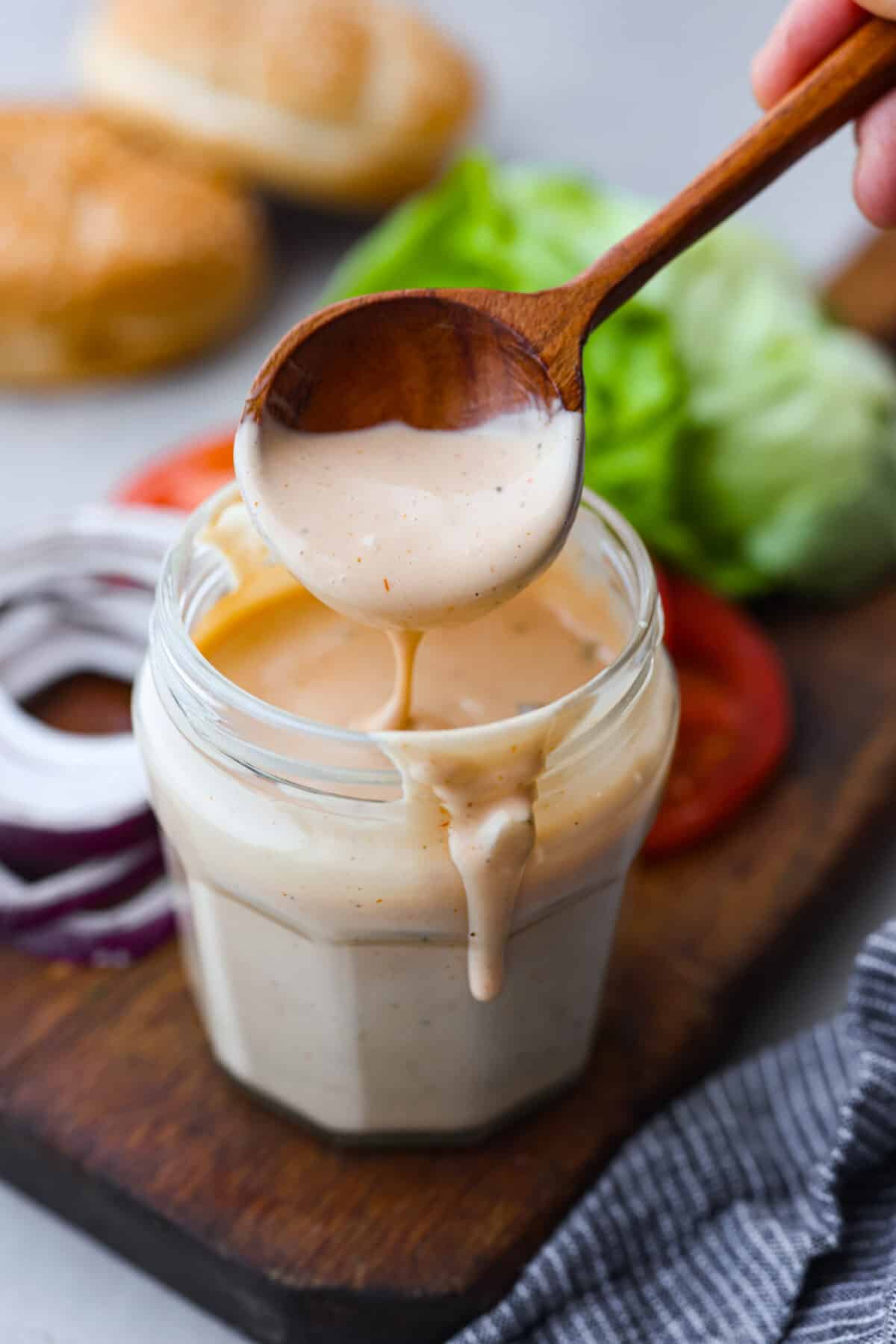 Burger sauce in a jar with a wooden spoon. 