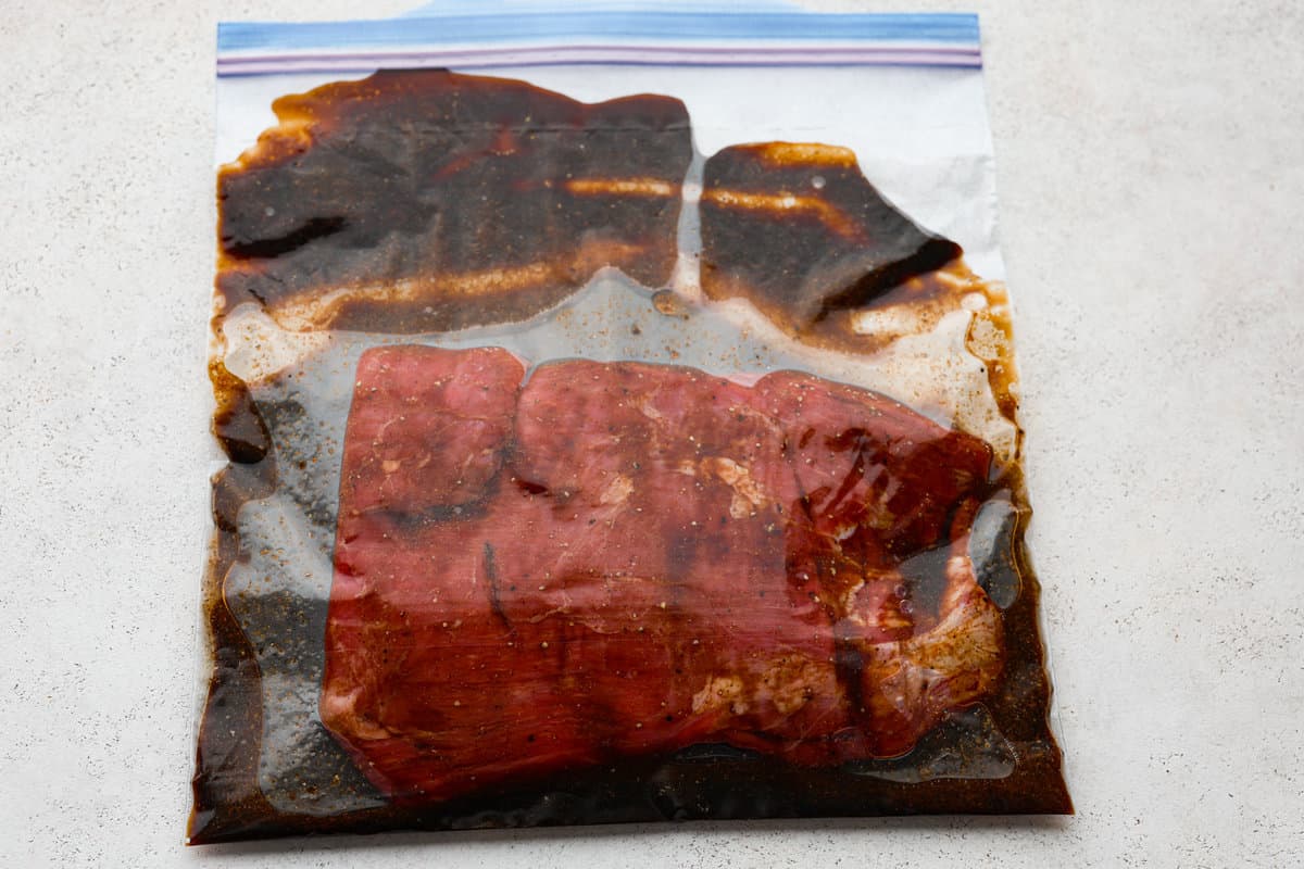 This delicious California Burrito is filled with well-seasoned grilled steak, pepper jack cheese, French fries, pico de Gallo, sour cream and avocado, all wrapped up in a warm flour tortilla. A flavorful lunch or dinner option that will be an absolute hit! Skirt steak marinating in a plastic bag for the California burritos.