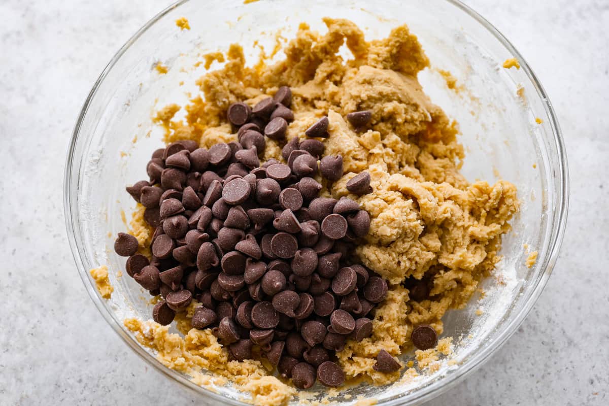 Introducing the softest and chewiest chocolate chip pudding cookies to ever come out of your oven! Adding Instant pudding mix creates the perfect cookie that dreams are made of. Fourth photo of the chocolate chips added.