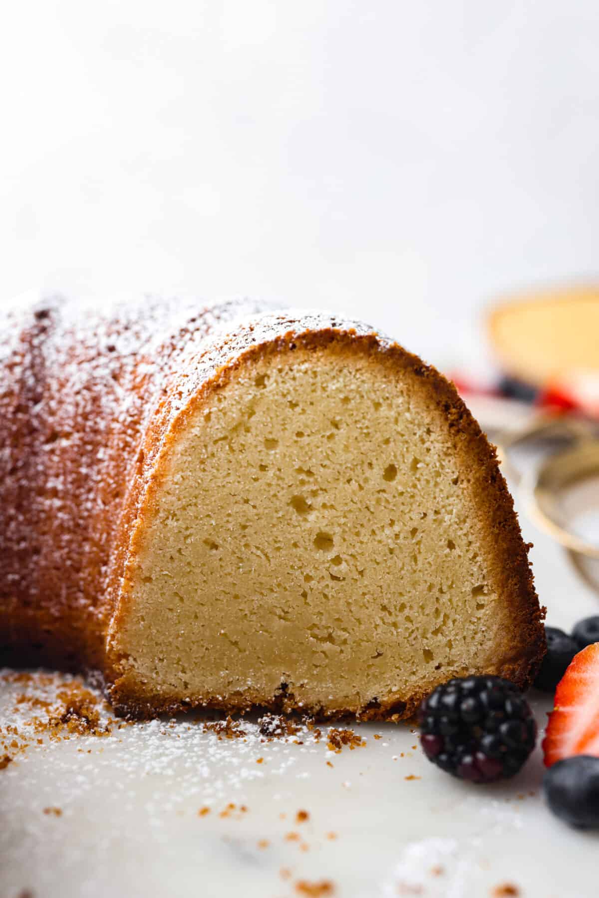 A bundt cake with a slice cut out of it so you can see the inside.