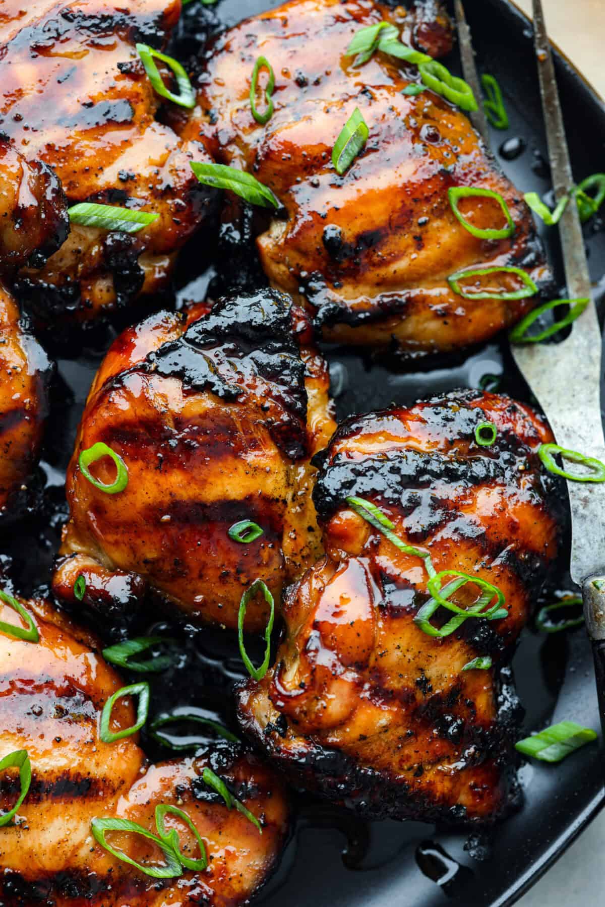 A close up of grilled chicken thighs marinated in bourbon. 