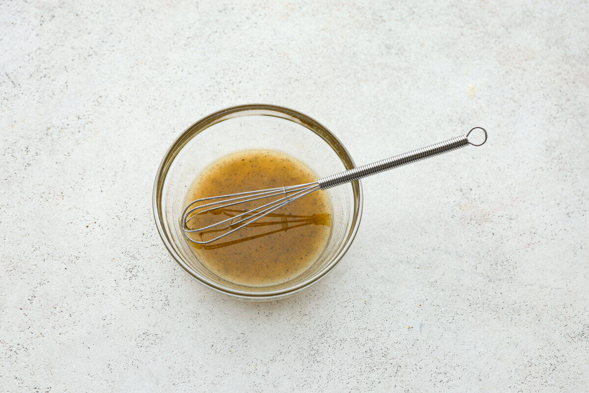 Marinade whisked in a clear glass bowl. 
