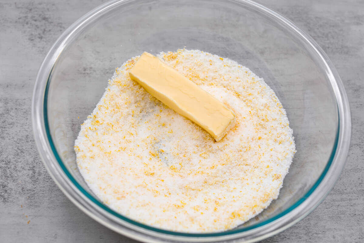 Lemon crinkle cookies are thick, soft pillows of lemon deliciousness! They have a refreshing flavor with an irresistible chewy texture. The perfect balance of sweet and tart make these a welcome treat for any occasion! The sugar, butter, and lemon zest being combined.