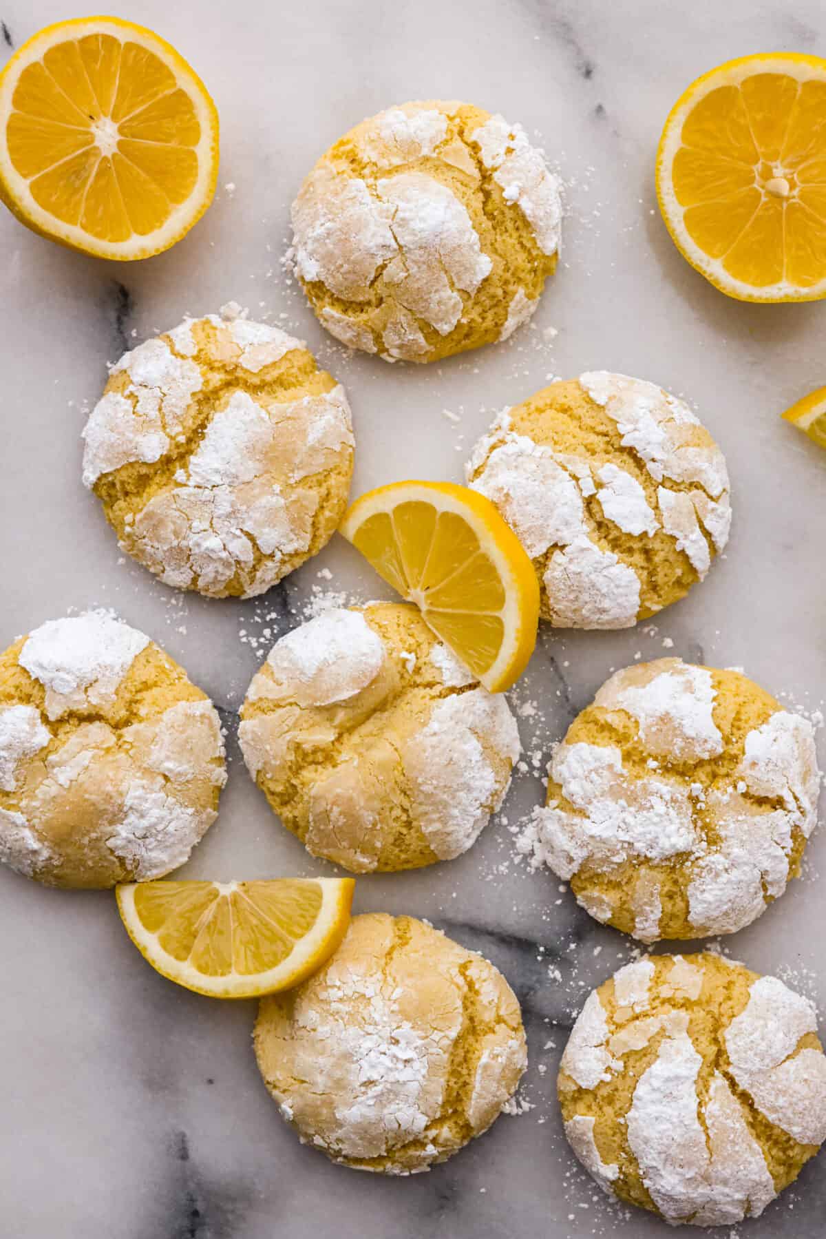 Top-down view of the lemon crinkle cookies, garnished with lemon slices