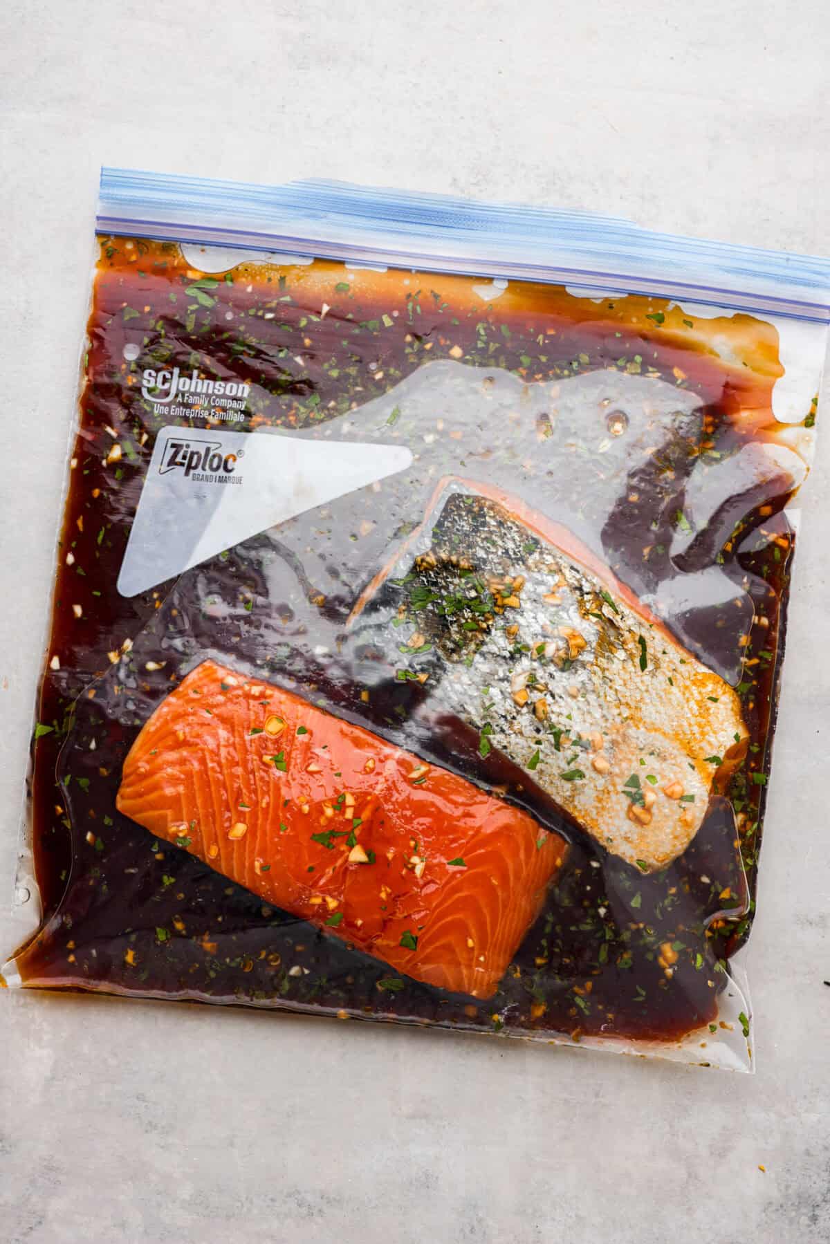 Salmon filets in a ziplock bag with marinade. 