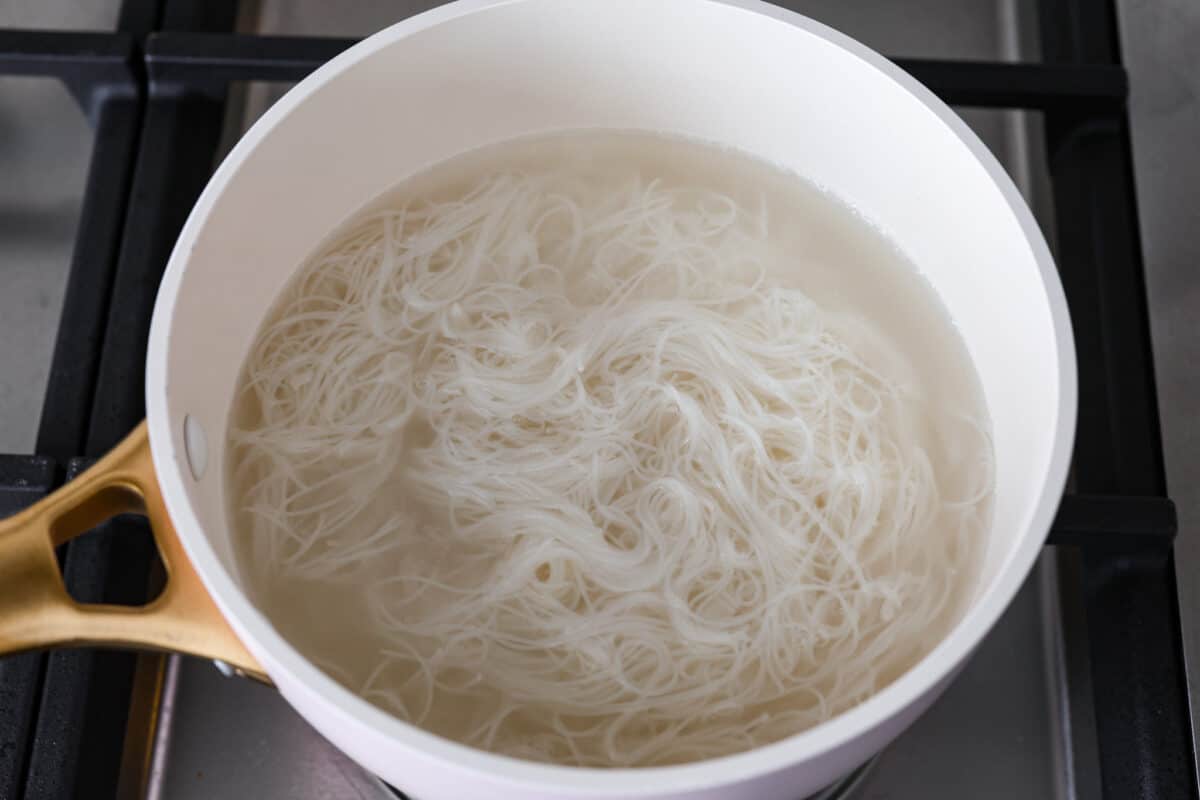 Noodles in a pot in water on the stove. 